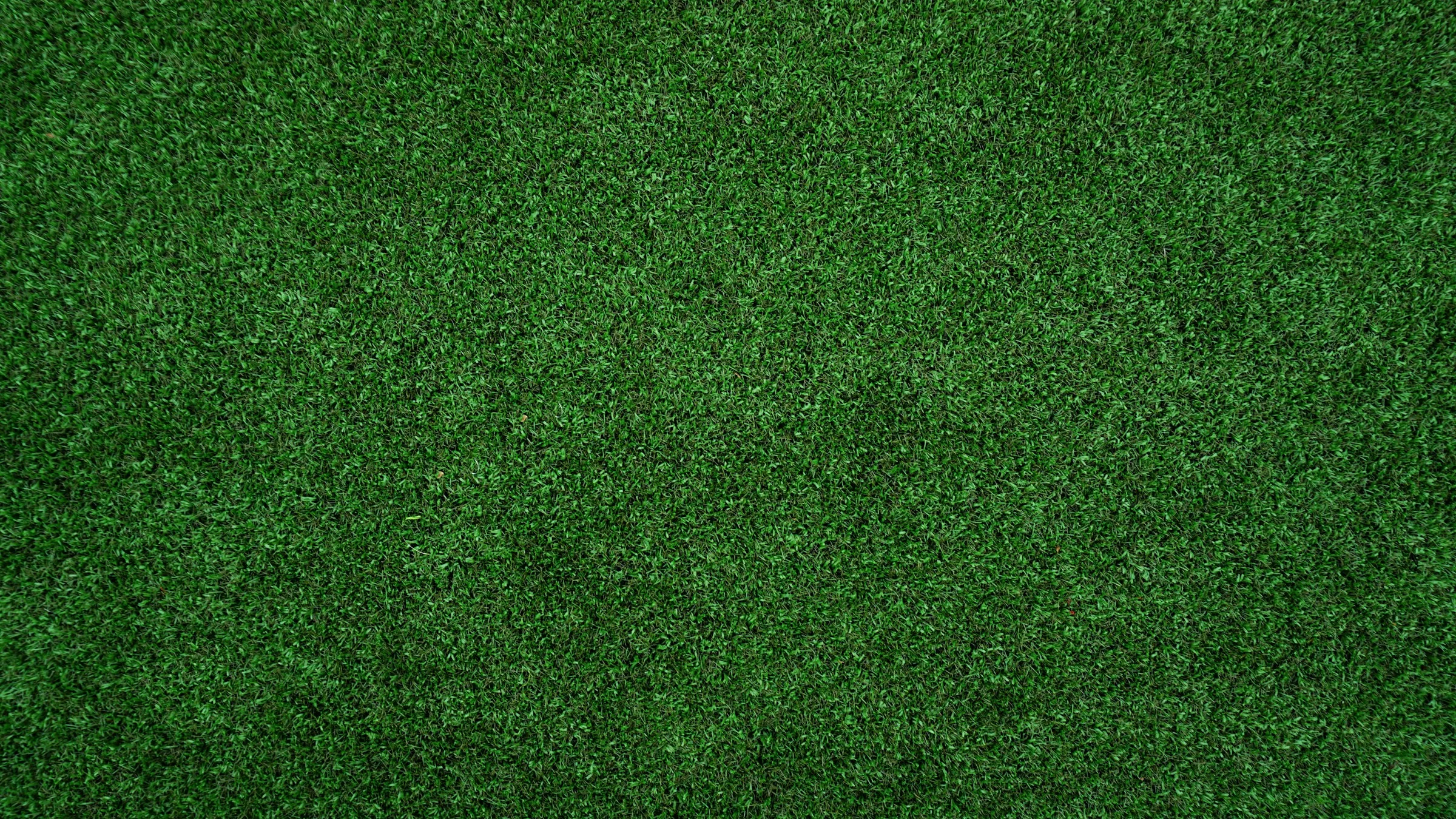 Close view of dense green artificial turf fibers