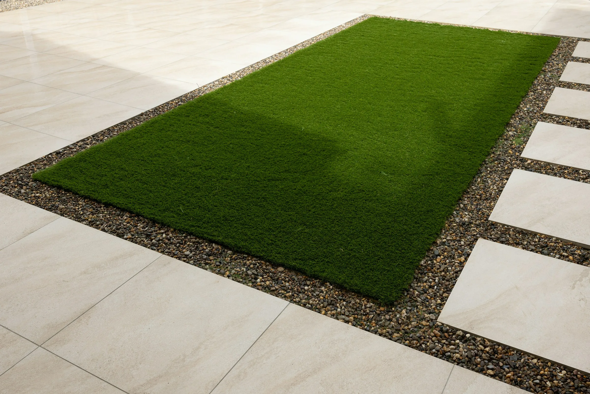 Artificial turf installed in a compact modern backyard