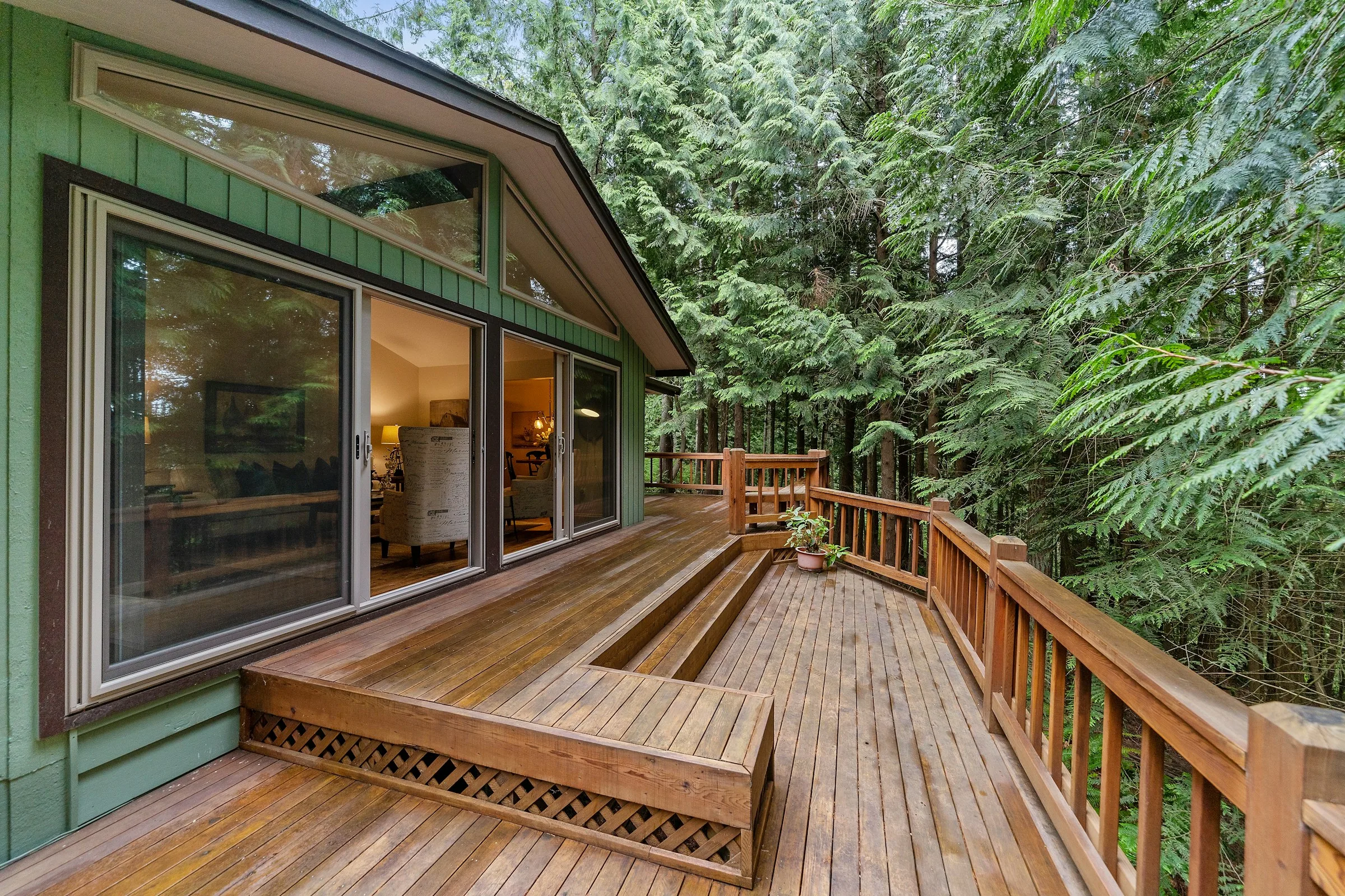 Wood deck extending into a lush forested setting
