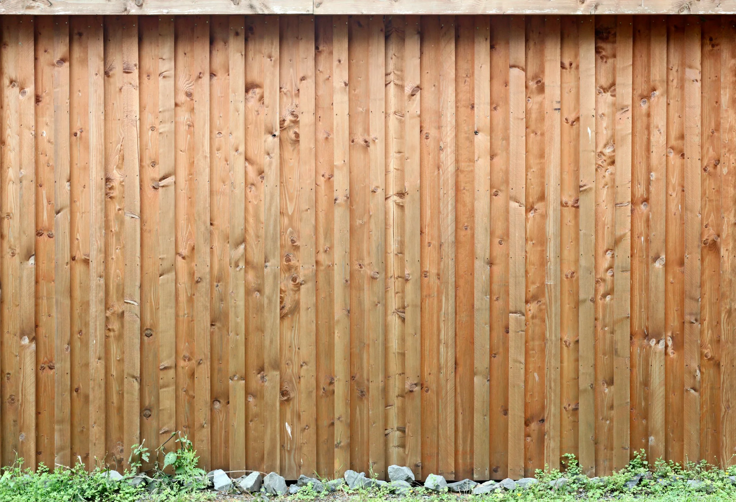 Long run of newly installed wood privacy fencing