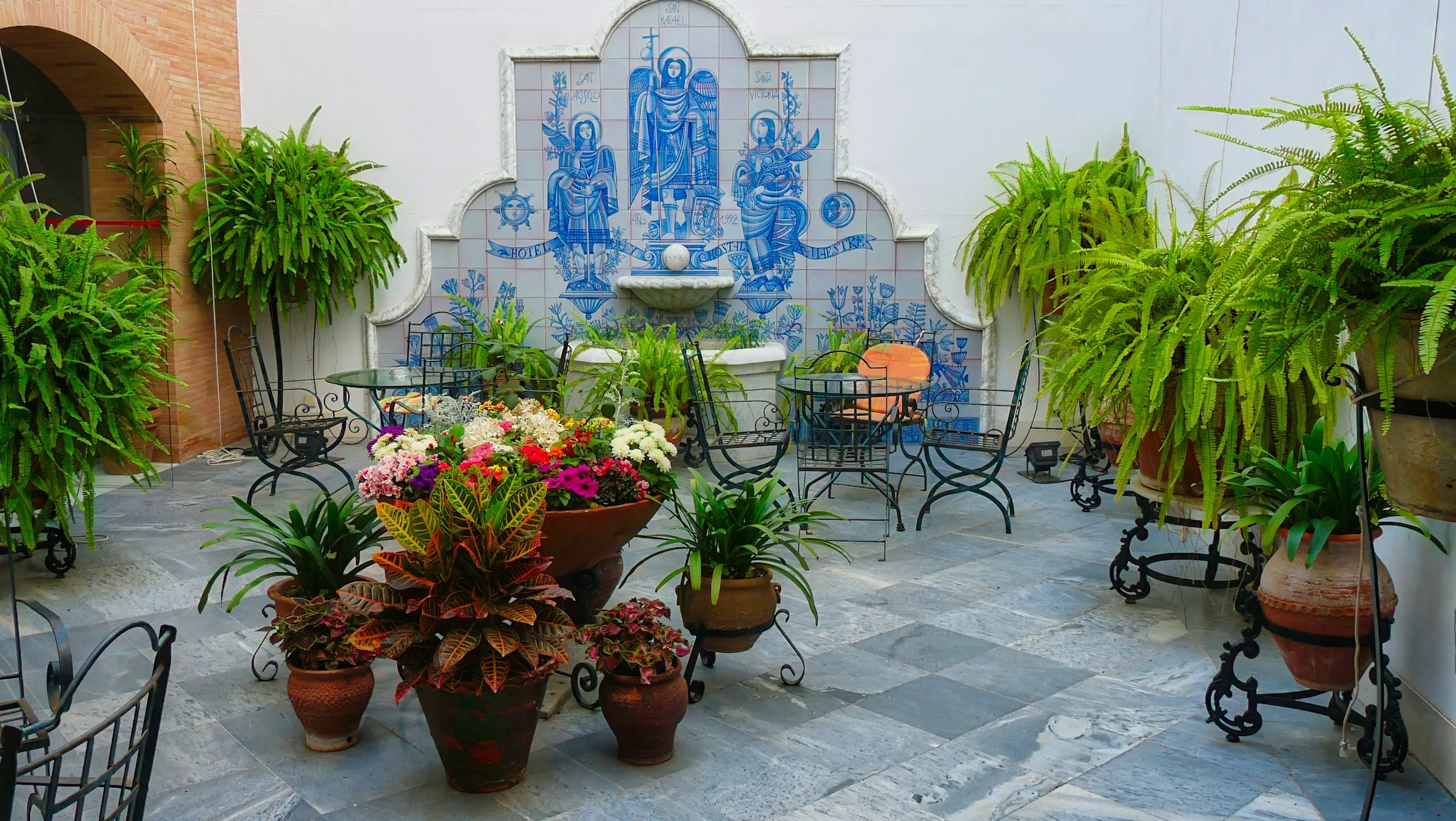 Flower-filled courtyard with a small garden fountain