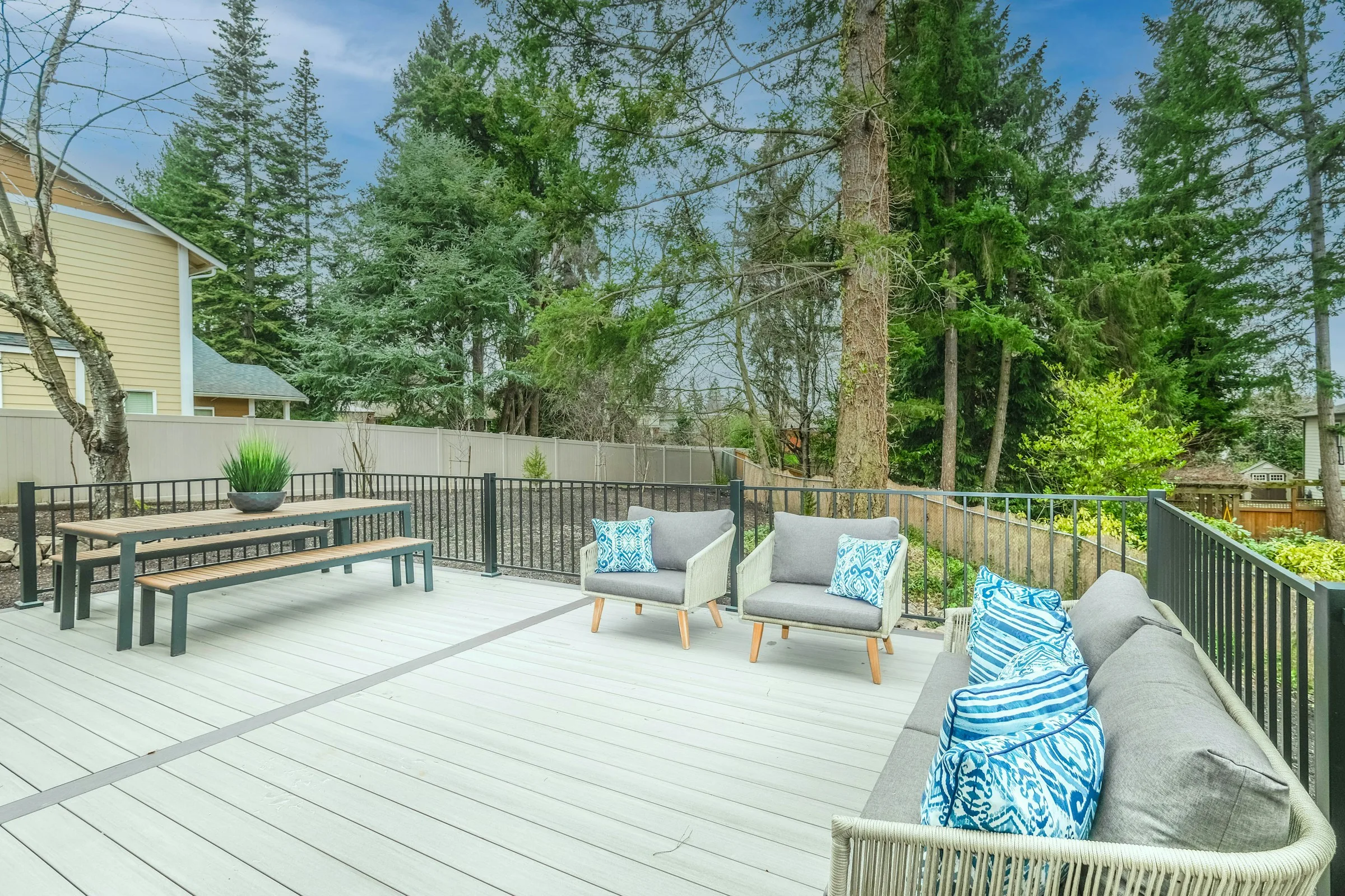 Contemporary backyard patio with geometric paving and planting beds