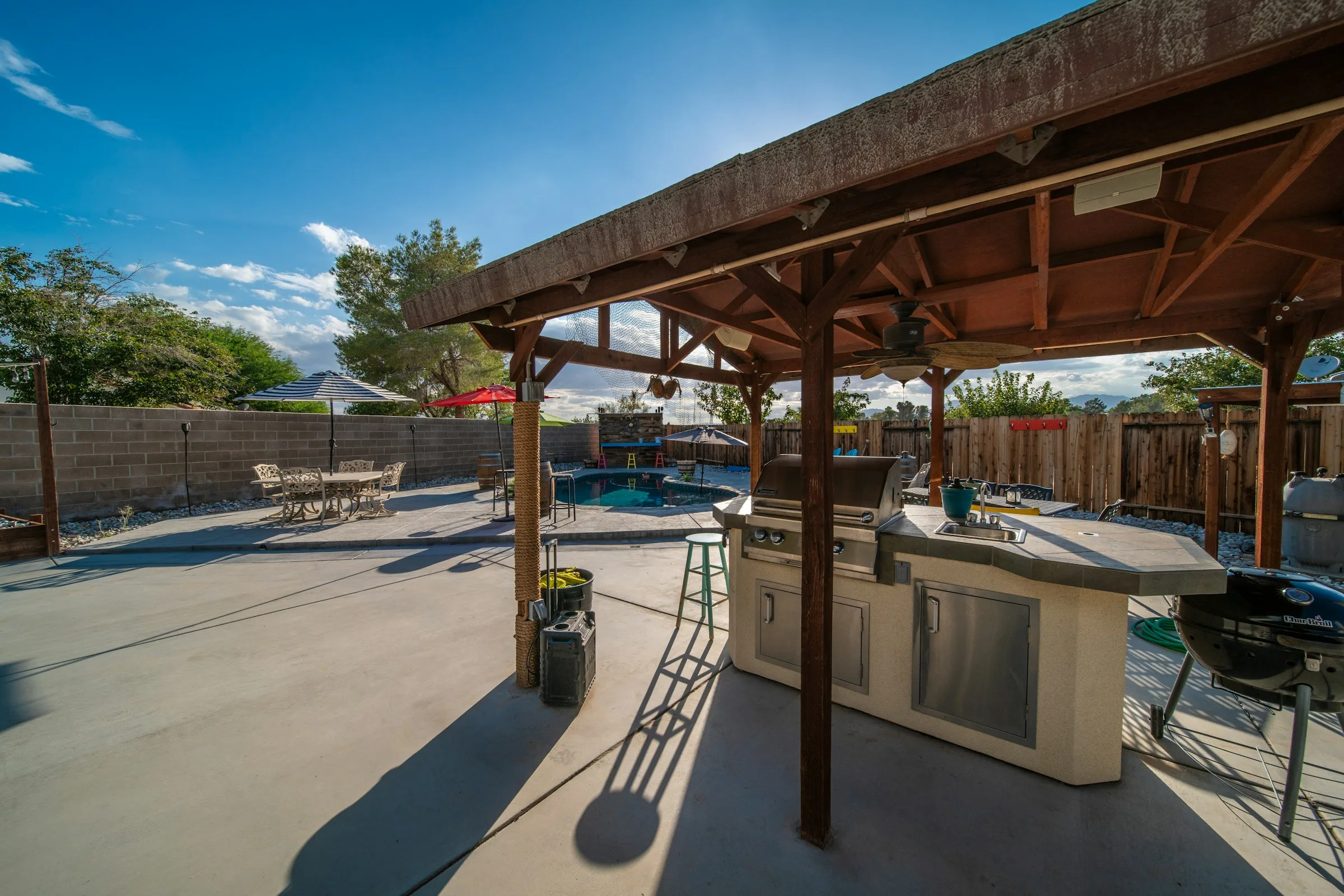 Outdoor kitchen and patio built into a landscaped backyard