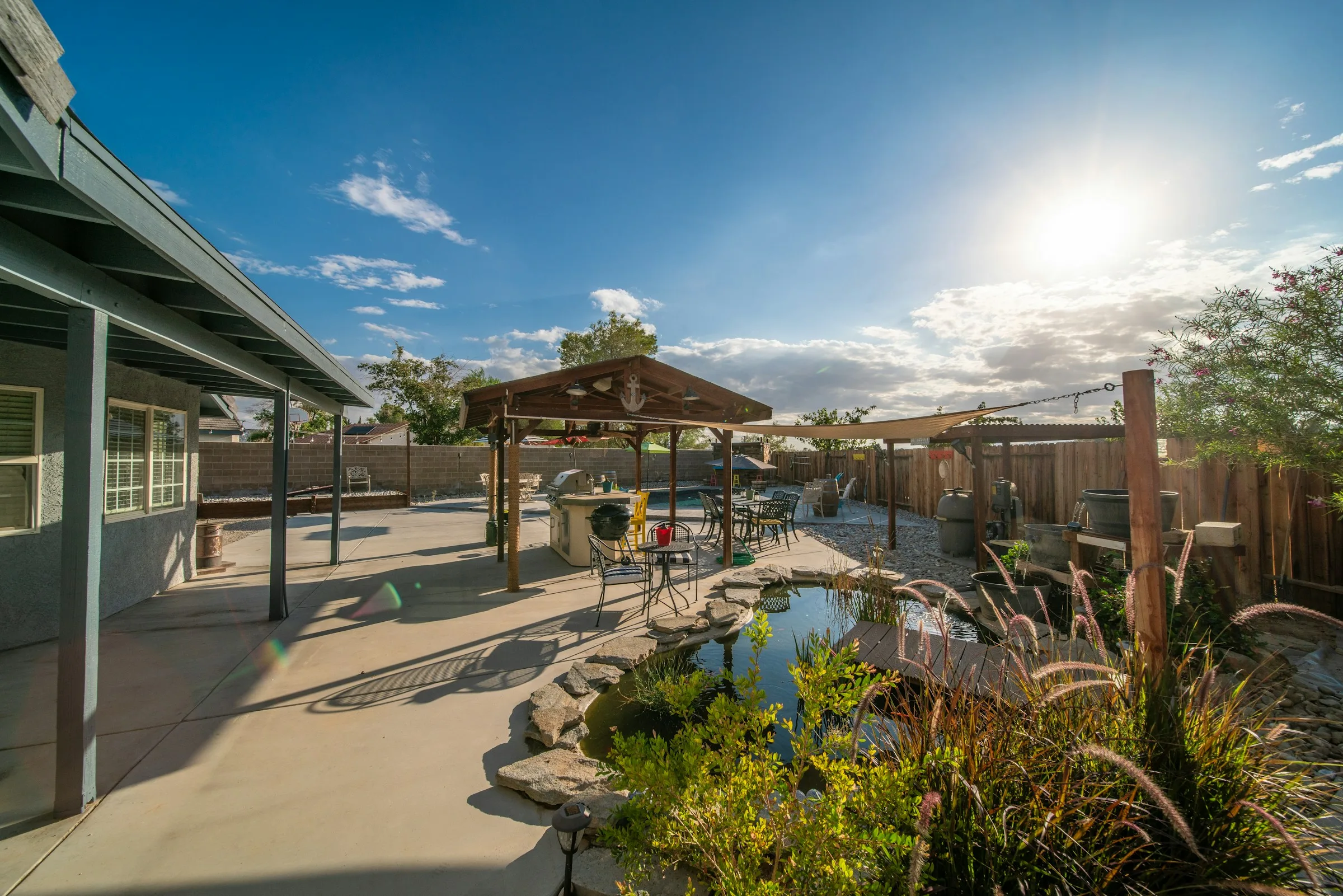 Stone patio beside a landscaped garden pond