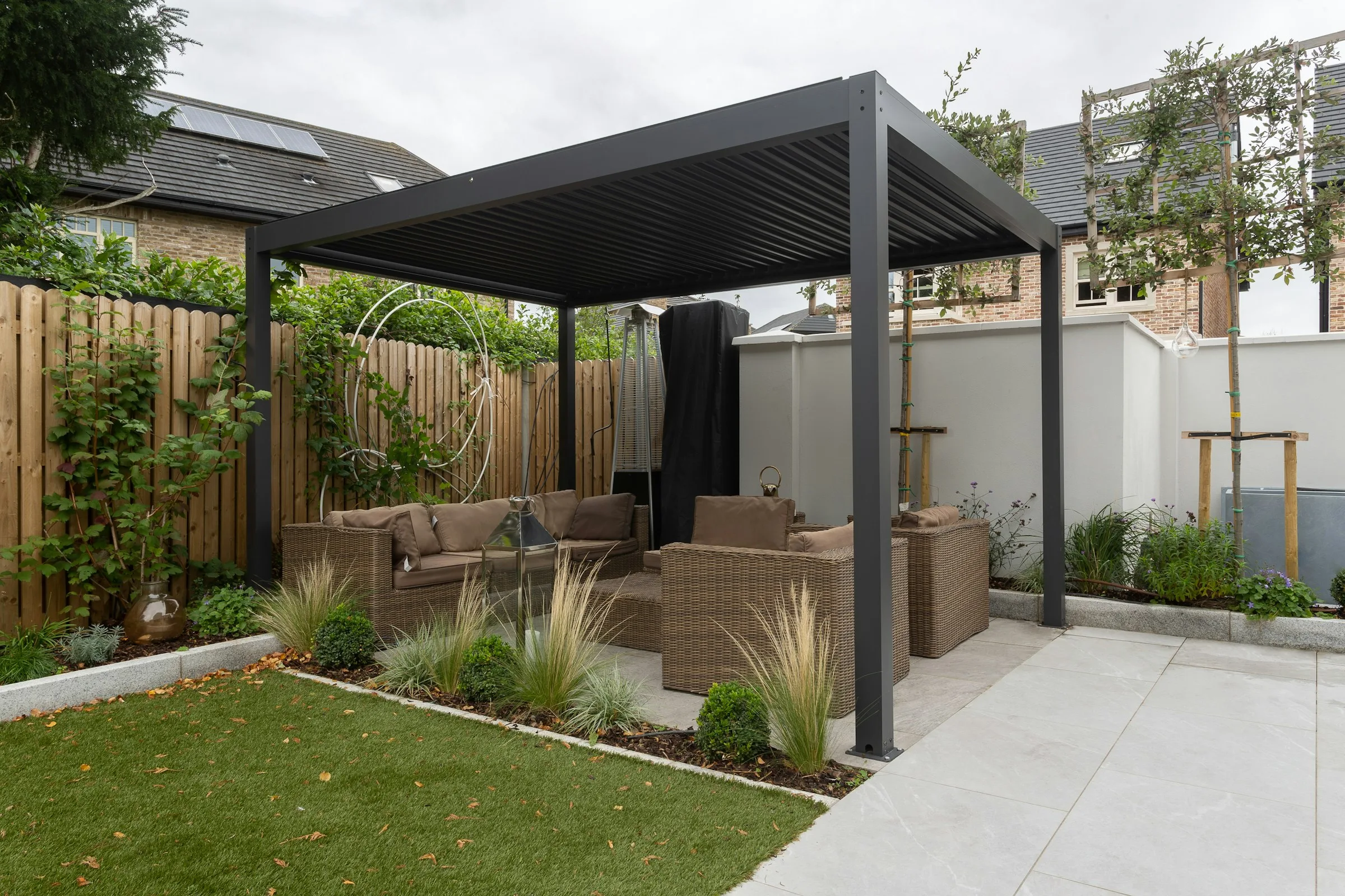 Modern louvered pergola covering a landscaped patio