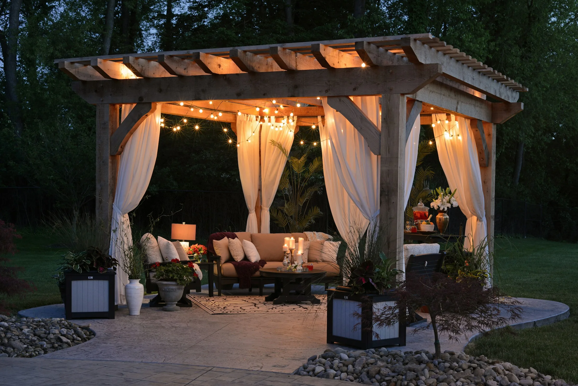 Freestanding backyard pergola with curtains and seating