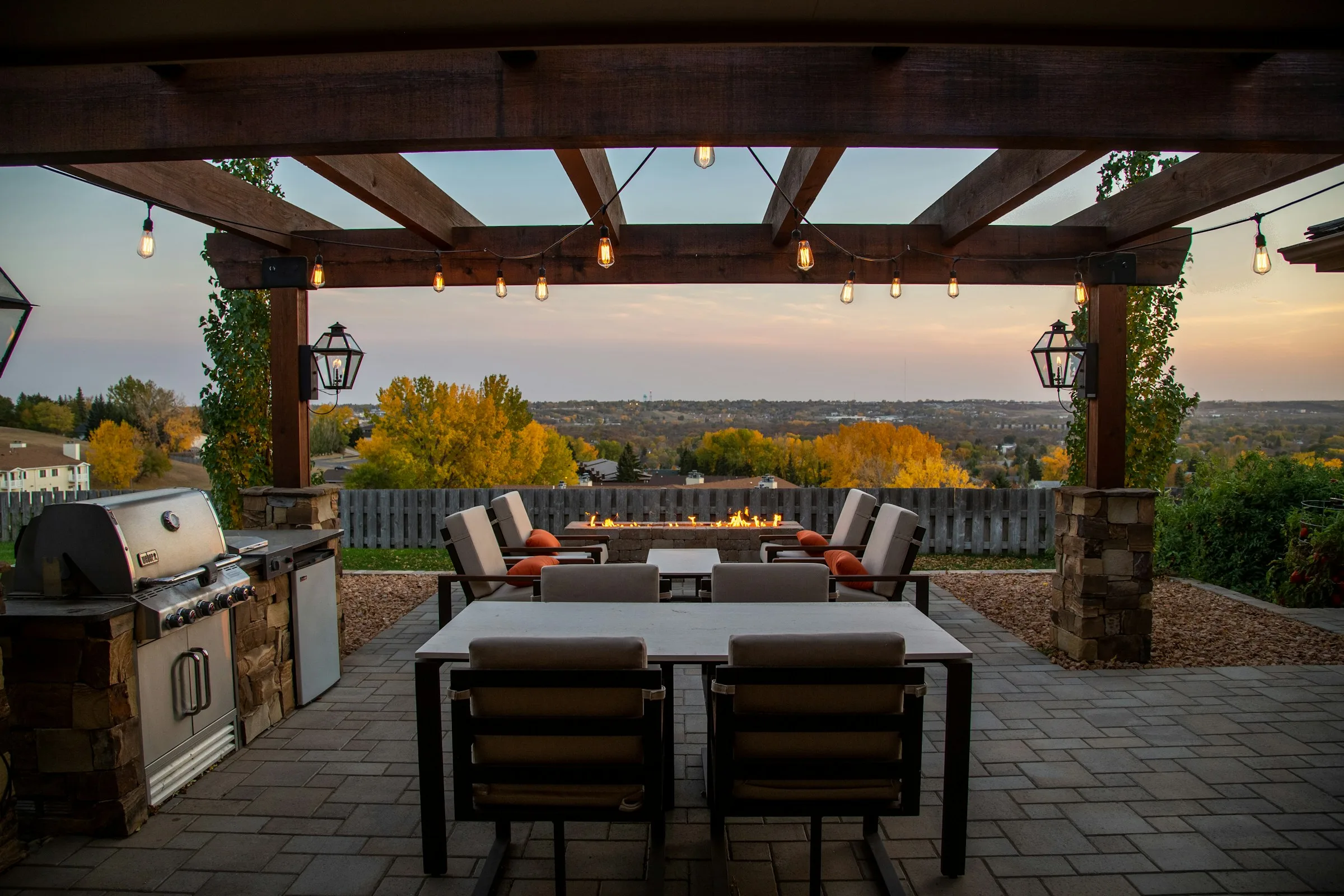 Timber pergola sheltering an outdoor kitchen and patio